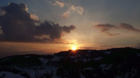 Aerial footage of amazing sunset over snowy mountains 