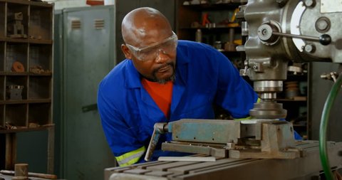 Attentive African-american metalsmith working in workshop