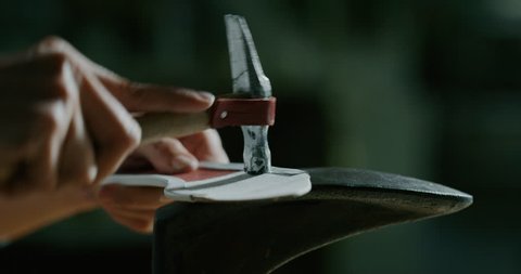 Close up of a shoemaker nailing and fixing the leather of the shoe according to the italian tradition. Concept: handmade, fashion, industrial, factory