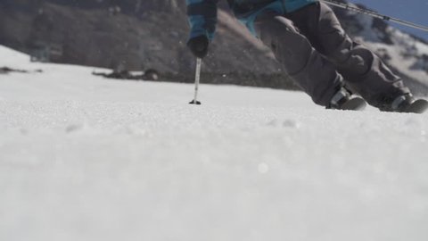 Slow motion skier turning on flexing snow skis