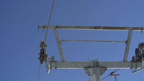 Chairlift tower cable and wheels at ski resort