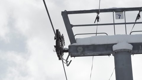 Snowy chair lift tower at ski resort