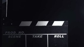 Movie clapboard action . Close up. Black background