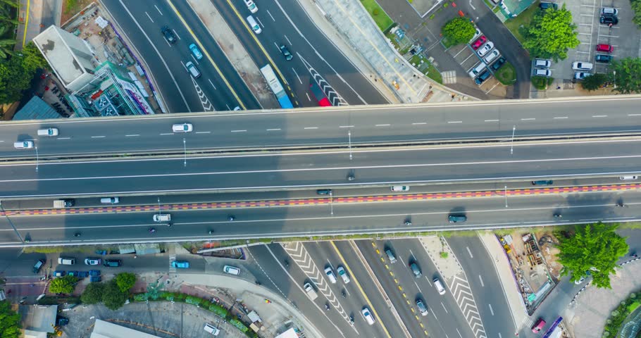 Top down view time lapse/hyperlapse of overpass and Sudirman highway with fast traffic in the Central Business Disctrict of Jakarta, Indonesia. Shot in 4k resolution