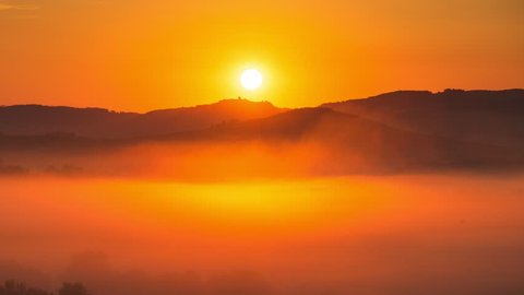 Time lapse of sunrise at misty morning, Tuscany, Italy