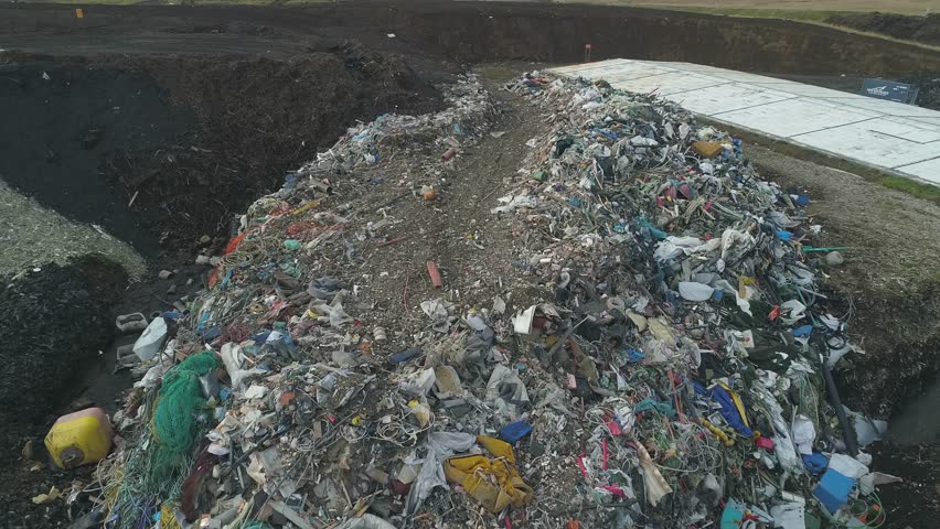 Aerial: City dump landfill Top-down view 
 Pile of garbage plastic waste buried underground Royalty-Free Stock Footage #1018865791