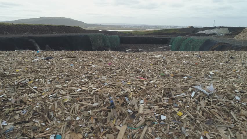 Aerial: City dump landfill Pile of garbage plastic waste buried underground | Shutterstock HD Video #1018865863
