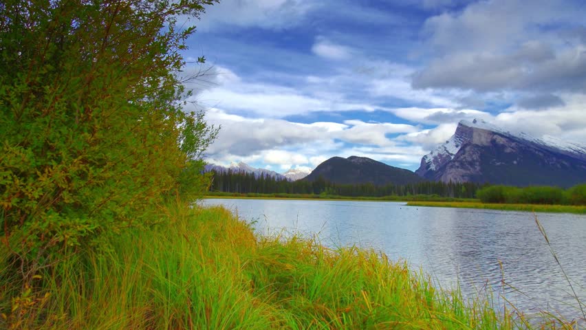 Timelapse of Vermilion Lakes in - sunny day waterfront view in Banff National Park, Canada.