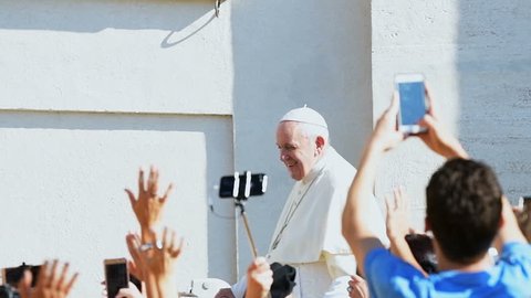 Vatican City State - September 5, 2018: Slow motion of Pope Francis riding, moving on popemobile, papal car, at general audience, people greeting, taking photos, waving hands, South Vietnam flag