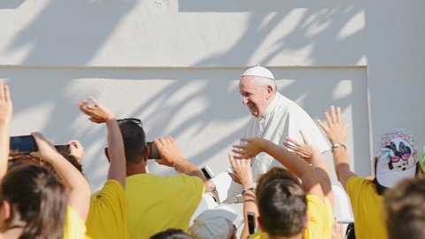 Vatican City State - September 5, 2018: Slow motion of Pope Francis moving, riding popemobile, papal car, at general audience, people greeting, taking photos, waving hands, blessing with hand, smiling