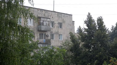 Rain, birds sound with old soviet apartment flat buildings in Rivne, Ukraine summer, weather raining, poverty architecture