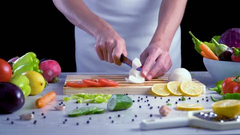 Chef is chopping black radish in the kitchen, slicing black turnip