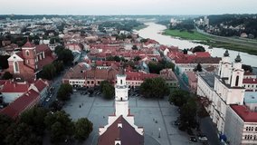 Aerial view of Kaunas city hall in old town. Drone video flying over city hall building slowly turning camera down.