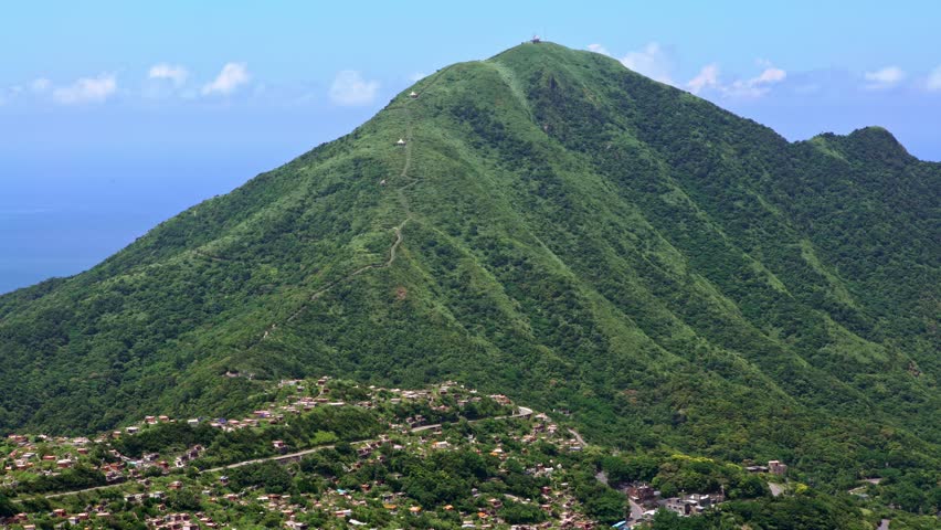 4K, Aerial view of Keelung harbor and mountain in New Taipei city. Beauty landscape of green mountains and port with blue sky. Scenic waterfront at beautiful day of summer in Jishan-Dan