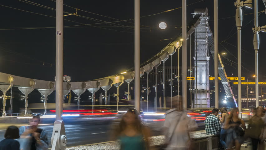  moon rising above the automobile and pedestrian suspension bridge, time lapse