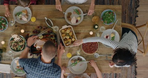 top view happy family enjoying thanksgiving lunch together enjoying tasty homemade feast holiday celebration meal overhead tracking
