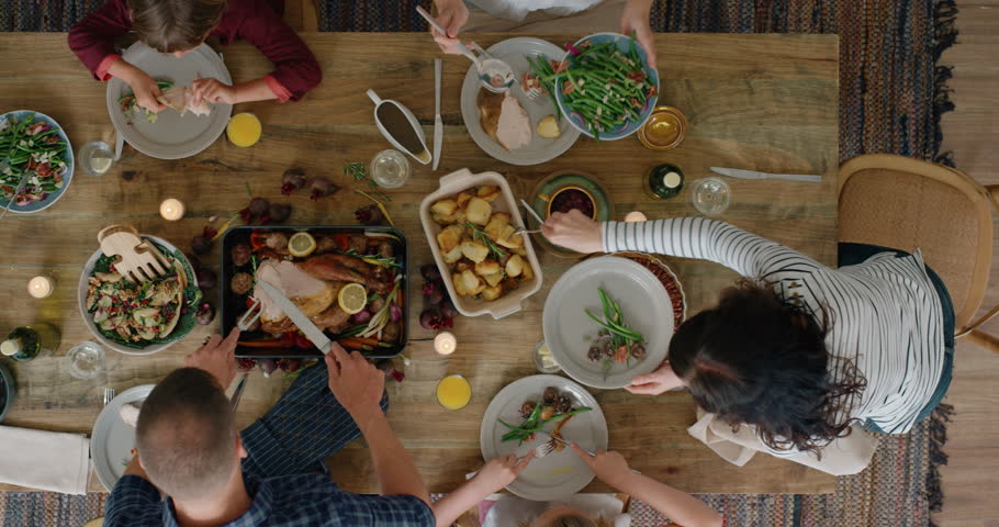 happy family eating thanksgiving lunch together enjoying healthy homemade feast holiday celebration holiday meal overhead tracking Royalty-Free Stock Footage #1018898260