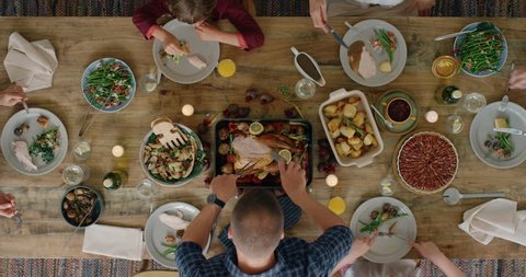 happy family eating thanksgiving lunch together enjoying healthy homemade feast holiday celebration holiday meal overhead tracking