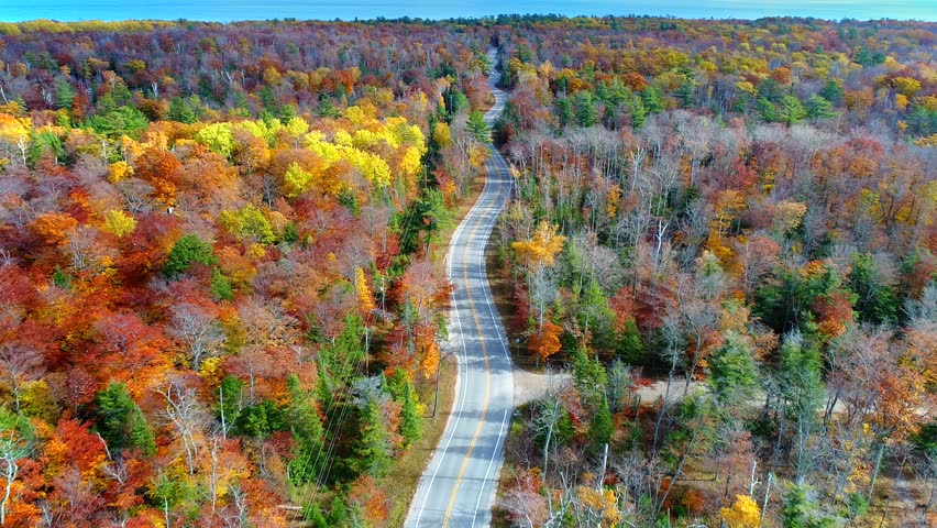 Aerial view of winding country road through breathtaking Autumn colors, aerial view. This is Highway 42 in Door County, Wisconsin.