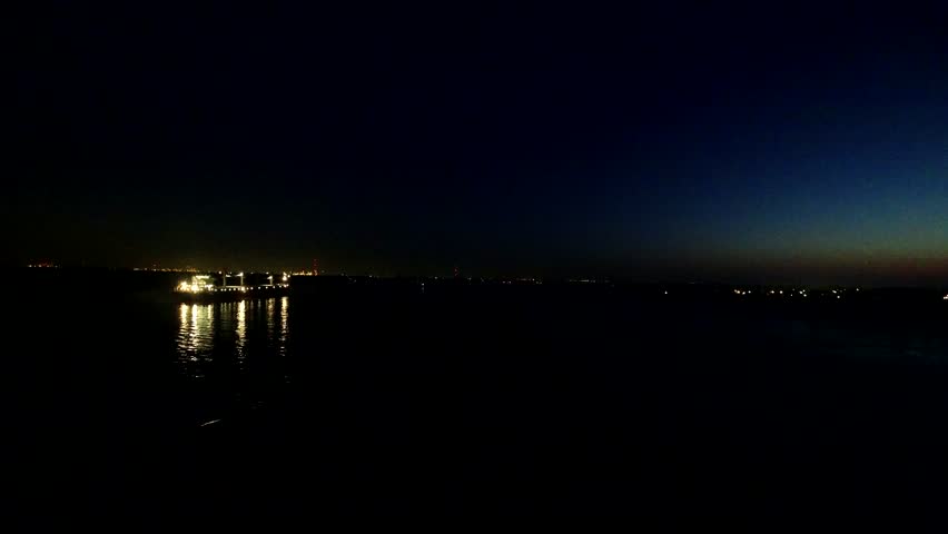 Oil tanker goes on the Mississippi River in the summer. Time lapse
