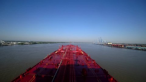 Oil tanker goes on the Mississippi River in the summer. Time lapse