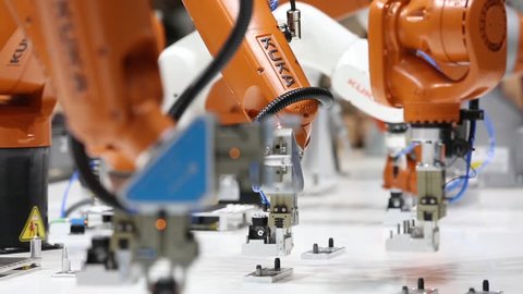 Hannover, Germany - April, 2018: Robot arms on Kuka stand on Messe fair in Hannover, Germany