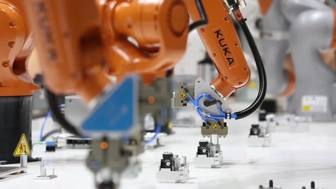 Hannover, Germany - April, 2018: Robot arms on Kuka stand on Messe fair in Hannover, Germany