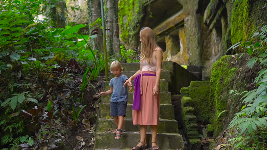 Slowmotion shot of a family visiting the Gunung Kawi Sebatu Temple on the Bali island