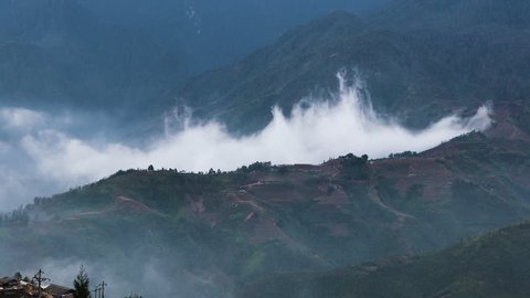 Time-lapse of clouds racing over a mountain top in Sapa Valley Vietnam.