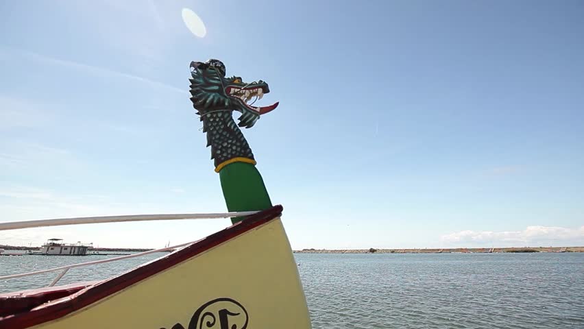Small motor boat dragon figurehead looking ahead