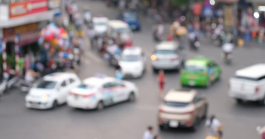 Defocus or out of focus traffic. Day traffic in downtown Hanoi city with lots of motorcycles, motorbike, bus, car, and people walking transport on the road. Aerial view city in rush hour