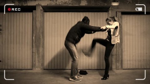 Young woman victim of an assault in the basement: the girl practicing a self defense technique