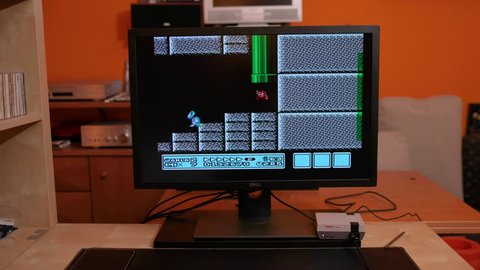 BUDAPEST, HUNGARY - FEBRUARY 17, 2018: Playing Super Mario Bros 3, the classic Nintendo NES game from the 80s