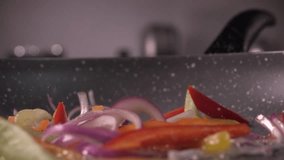 Sliced bell pepper and onion being dropped into a pan from wood, 240 fps - Powered by Shutterstock - Get 15% off with code: PIKWIZARD15