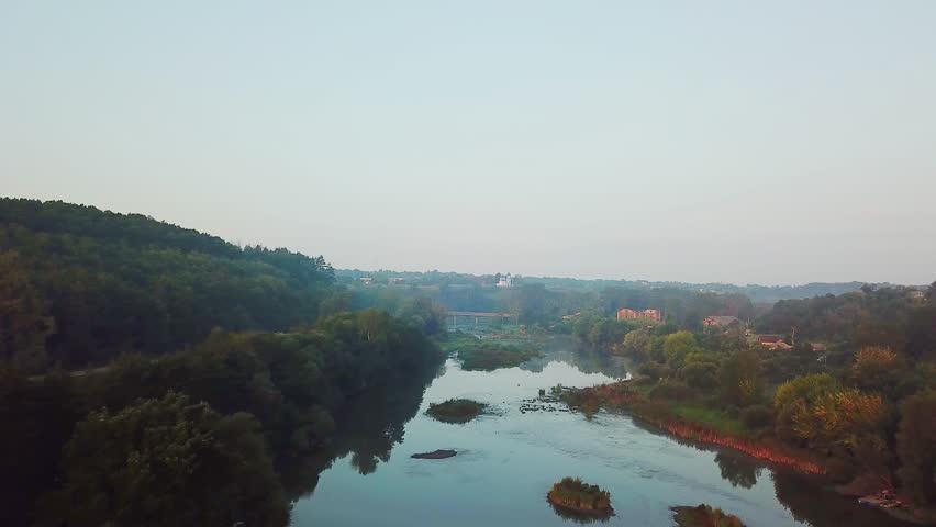 river at dawn with a bridge and a church in the background, aerial view of river at sunrise, aerial view of morning fog at sunrise, Aerial view of the dawn over the river in the fog