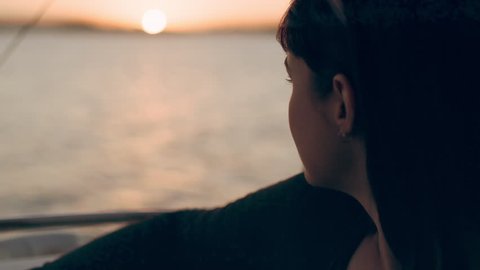 Friends cruising on a boat watching a beautiful sunset in Australia. Medium close on 4k RED camera.の動画素材
