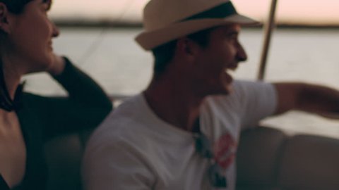 Friends cruising on a boat watching a beautiful sunset in Australia. Medium close on 4k RED camera.