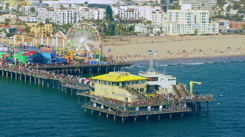 Aerial view of Santa Monica Pier shoreline on a sunny day in Los Angeles, California. Shot on 4K RED camera.