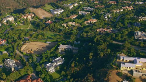 Aerial view of Beverly Hills mansions on a sunny day in Los Angeles, California. Shot on 4K RED camera.