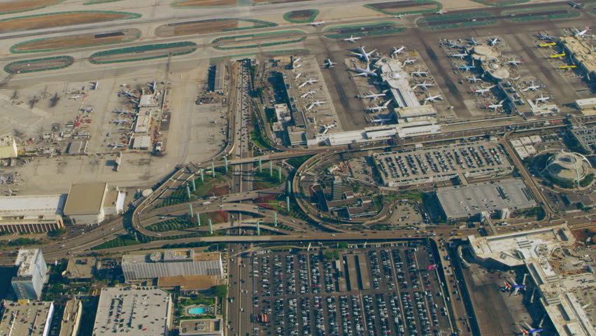 Aerial view of airplanes at terminals at LAX runway on a sunny day in Los Angeles, California. Shot on 4K RED camera. Royalty-Free Stock Footage #1018970668