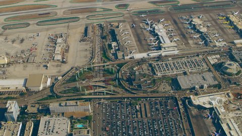 Aerial view of airplanes at terminals at LAX runway on a sunny day in Los Angeles, California. Shot on 4K RED camera.