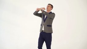 a man in a suit skillfully is copying the movements of a boxer during a fight in the studio. Parody from actor