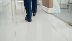 man in business clothes is running through the building to the workplace. Late during working hours