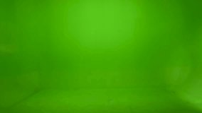 Closeup of male hand pushing TV remote control . Green screen