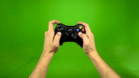 Frustrated gamer playing game match on green screen shaking game remote controller losing game
