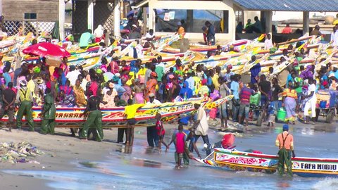 Dakar, Senegal - 07 25 2016: Dakar, Senegal - July 26, 2016: The typical Soumbedioune fish market in Dakar with fish-boat and sellers