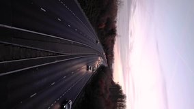 Vertical Video - Cars driving along a motorway at sunset