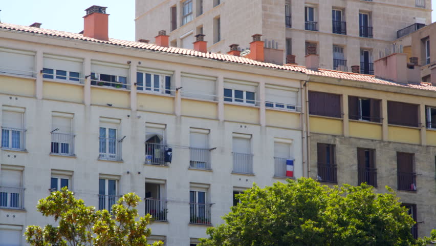 French flag on apartment building balcony window, Marseille, France