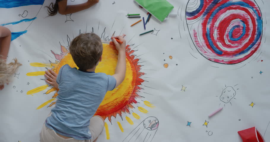 Young diverse children paint colorful space pictures together on paper using paint brushes happy kids enjoying fun creativity painting science fiction space drawing pictures top view | Shutterstock HD Video #1018997518