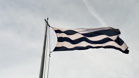 Flag of the city of Dunkirk in the north of France. It consists of six horizontal stripes alternating white and blue. It is located on the belfry of the city.